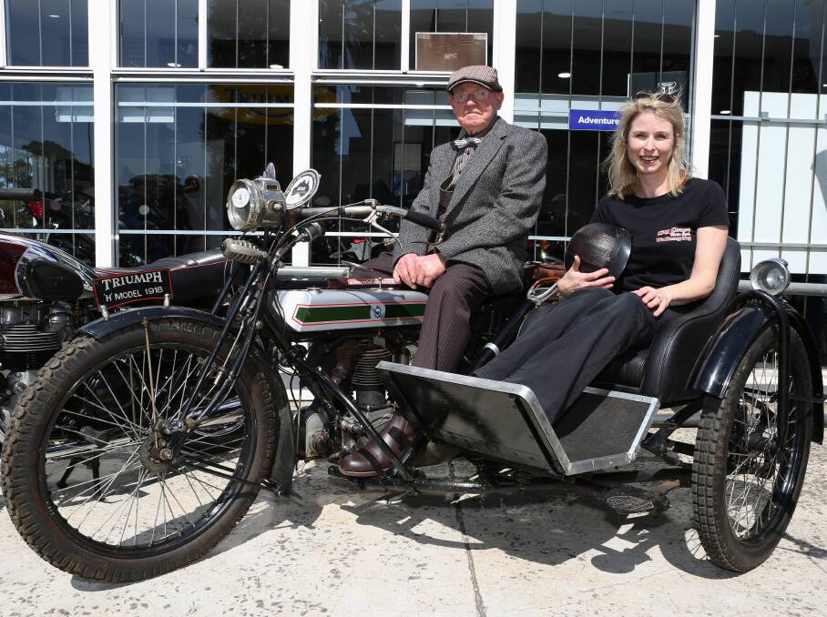 Riding for men's health: Denis Tobler shows Wollongong Distinguished Gentleman's ride co-organiser Jane Sim a 100 year old Triumph which is one of 40 old motorcycles in his collection. Picture: Greg Ellis.

