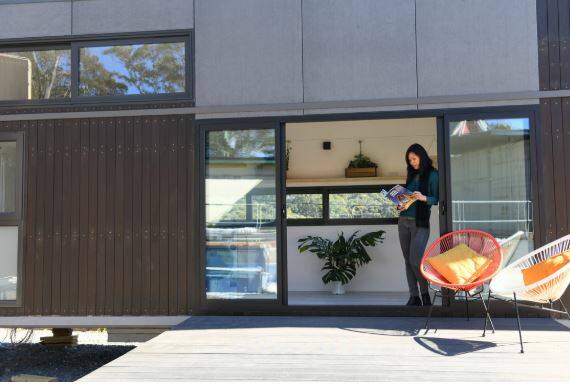 Modern styling: Diamond Hawkins with one of her stylish tiny homes at Helensburgh. Picture: Panorama Prebuilt.