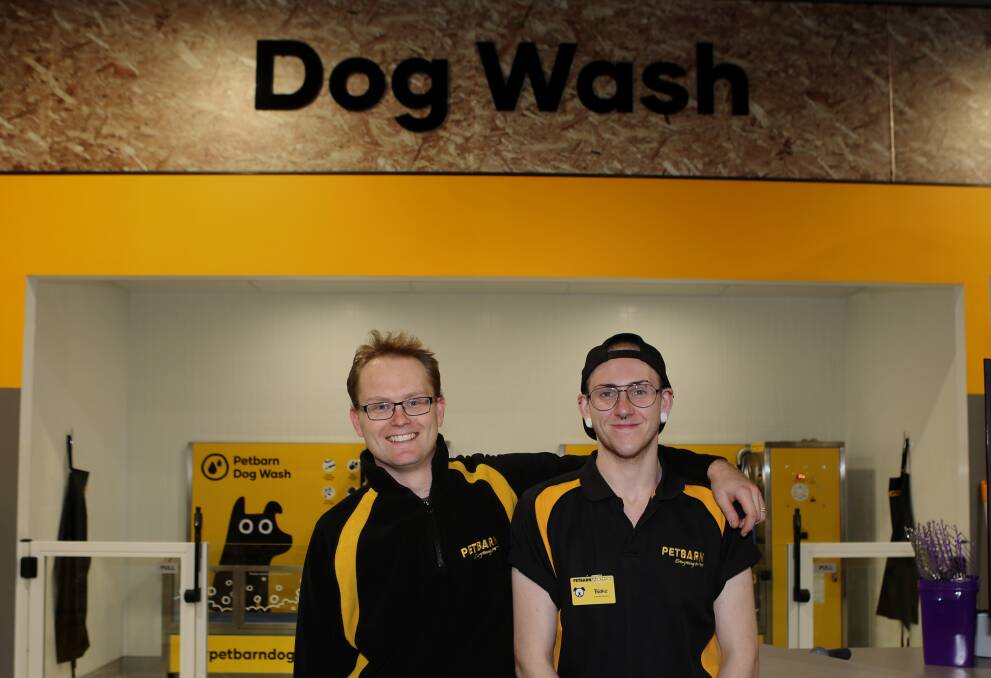 New concept: Brendan Fisher and Blake Wallace at the new Petbarn Shellharbour which will offer cat adoption and dog grooming when it officially opens on Saturday.