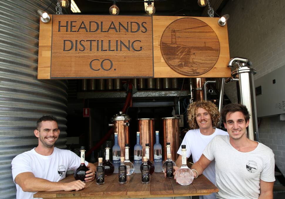Lifting their spirits: Lachlan Hingley, Jared Smith and Dean Martelozzo with the growing Headlands Distilling range at Fairy Meadow. Picture: Greg Ellis.
