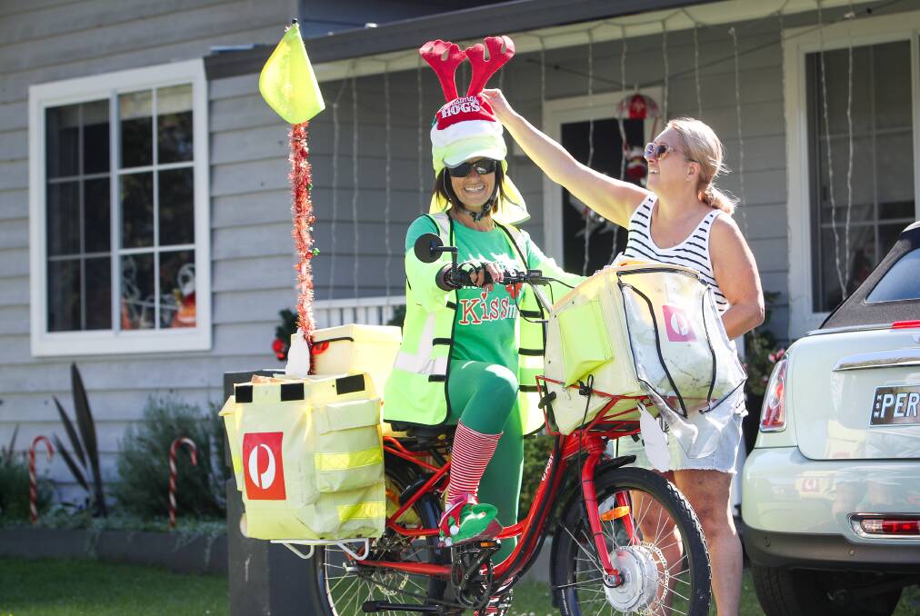Mary Christmas: Mary Mouawad chats to Peree Eager during her Christmas Eve mail delivery run in Bellambi. Picture: Adam McLean.

