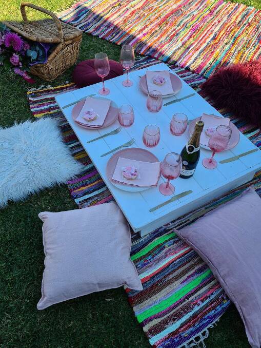 The Brassil family set up their Mother's Day picnic in the backyard.
