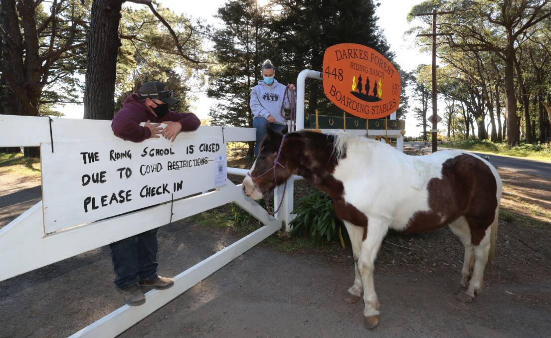 Owner Jules Read and GoFundMe page creator Colleen Kemp with Princess Patches outside the closed gate at Darkes Forest Riding Ranch. Picture: Robert Peet