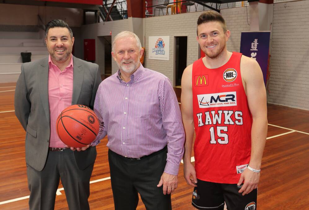 Community day: Jason Saladino, Michael Bassingthwaighte and Rotnei Clarke call for the community to come to a Hawks family day at Saint Mary's Star of the Sea College on Sunday. Picture: Greg Ellis.

