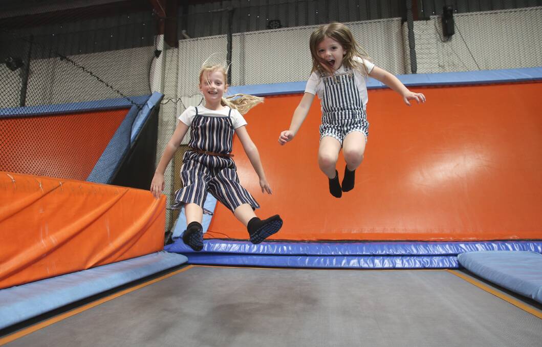 Flying fun: Caitlyn and Madison Whiteside enjoy one last chance to jump at Hangtime Trampoline Park on Saturday. The final chance for the community to bound is Sunday from 10am to 6pm. Picture: Anna Warr