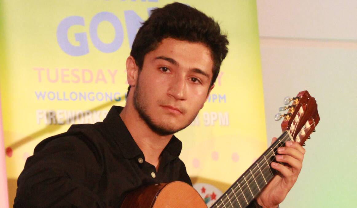 Rising star: Sako Dermenjian shows his talent as a classical guitarist at the Wollongong Australia Day Citizen and Achievement Awards. Picture: Greg Ellis

