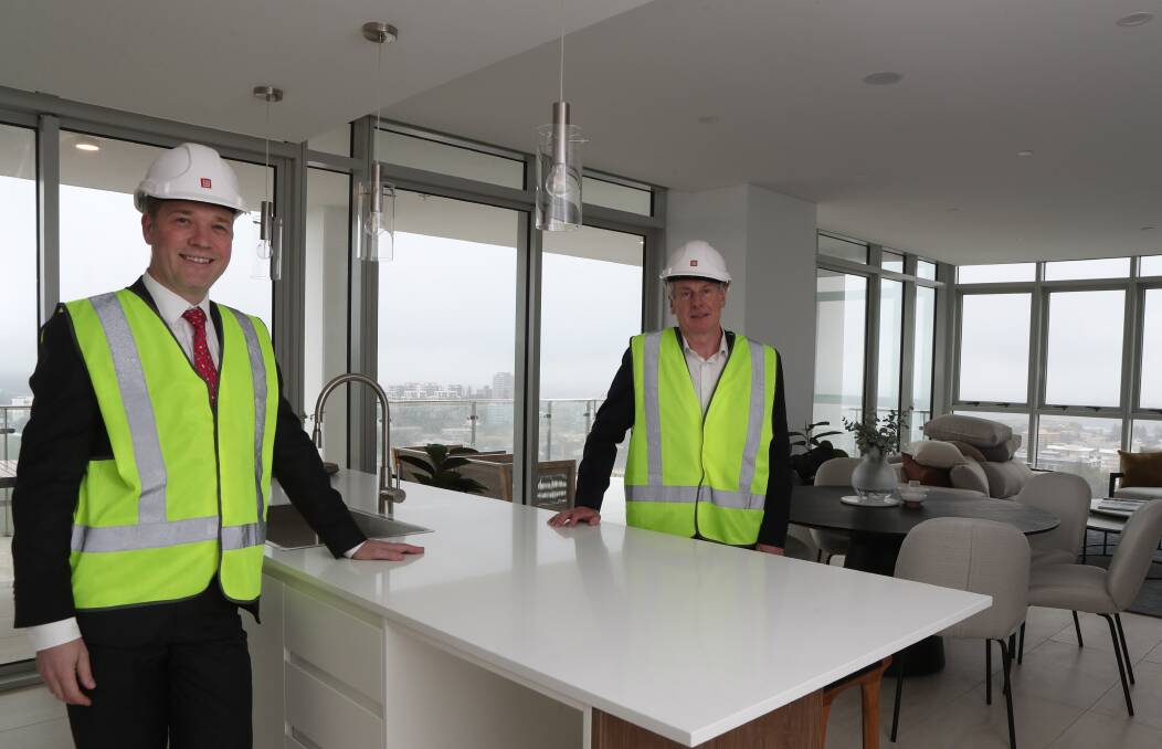 Reaching new heights: IMB Bank chief executive Robert Ryan celebrates the financial institution being recognised as one of Australia's best four banks in the soon to be completed 21-storey Signature Wollongong apartment building with Illawarra Business Chamber chief executive Adam Zarth. Picture: Robert Peet.

