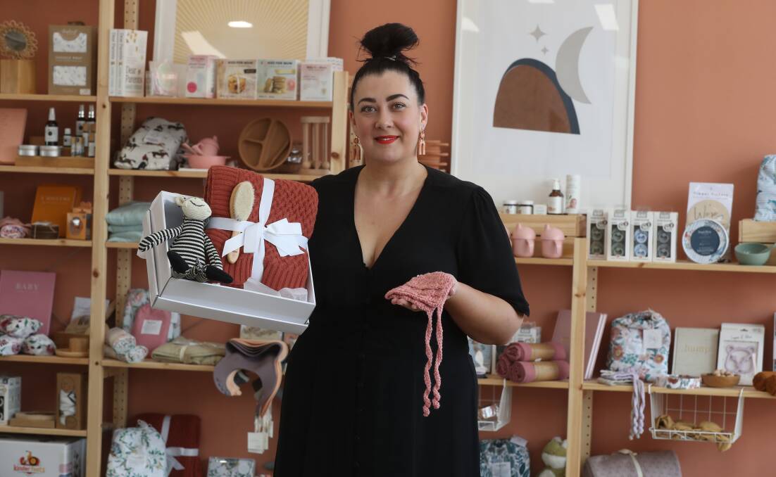 Black Friday chance to shop locally: Baby by Boutique Bundles owner Kellie Bates with a gift box of all Australian sourced products and a handmade crocheted baby's bonnet made by a local mum. Picture: Robert Peet.