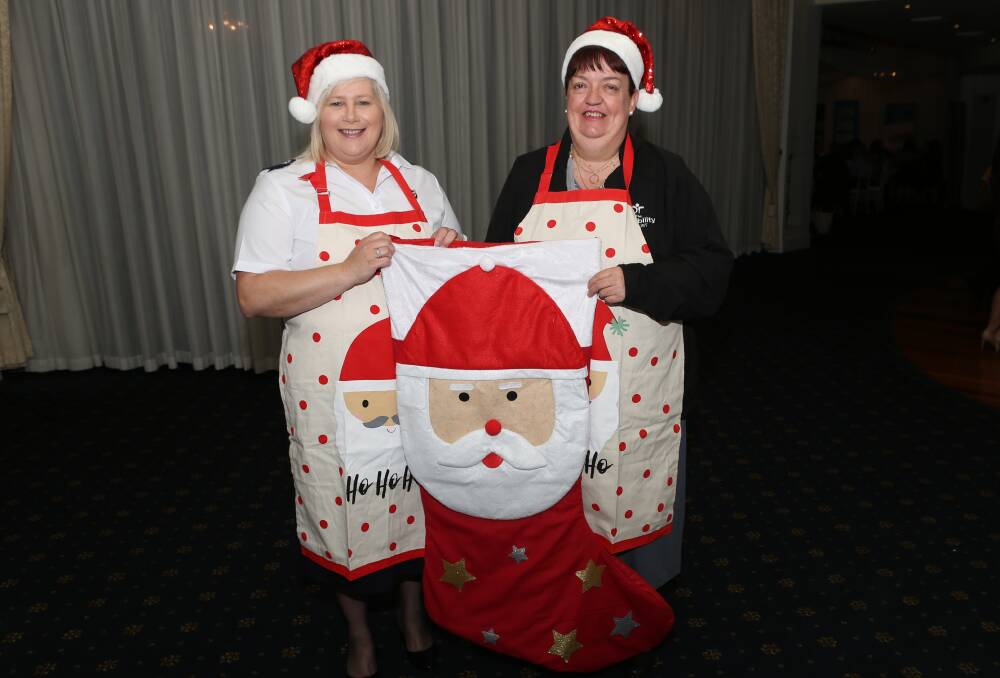 Santa's helpers: Karen Walker from the Salvo's and Margaret Biggs of the Disability Trust ready for Santa Fest Carols in Lang Park on Sunday. Picture: Greg Ellis.

