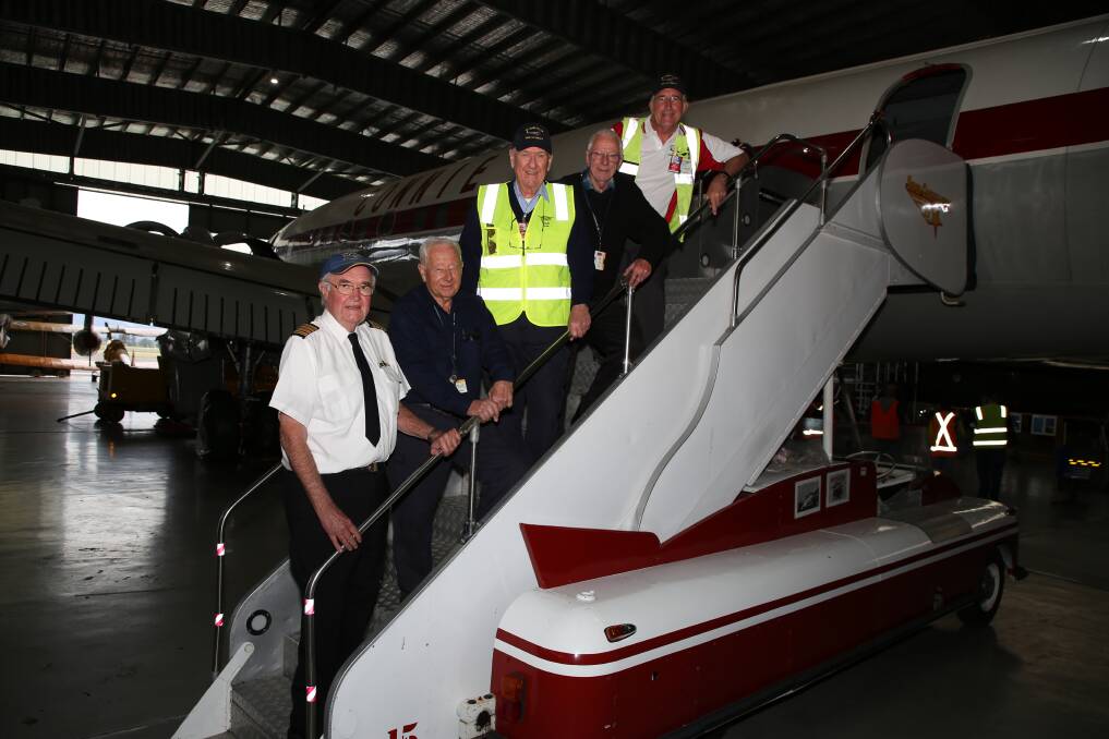 Stepping up: Reg Darwell, Jim Marshall, Don Hindle, Warren Goodhew and Dick Elliott with Connie and the steps the Beatles strode down when they arrived in Australia in 1964. Picture: Greg Ellis.
