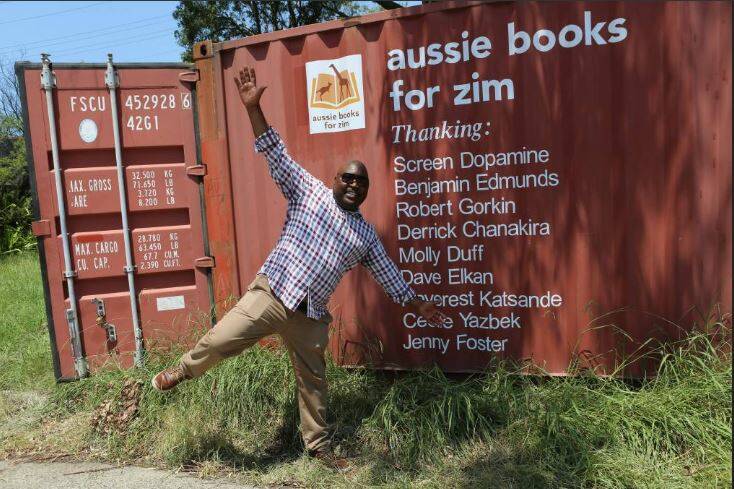 Dream being realised: Alfred Chidembo with the large shipment of books and stationary that left Wollongong in January bound for new libraries to be created in remote communities in Zimbabwe. 