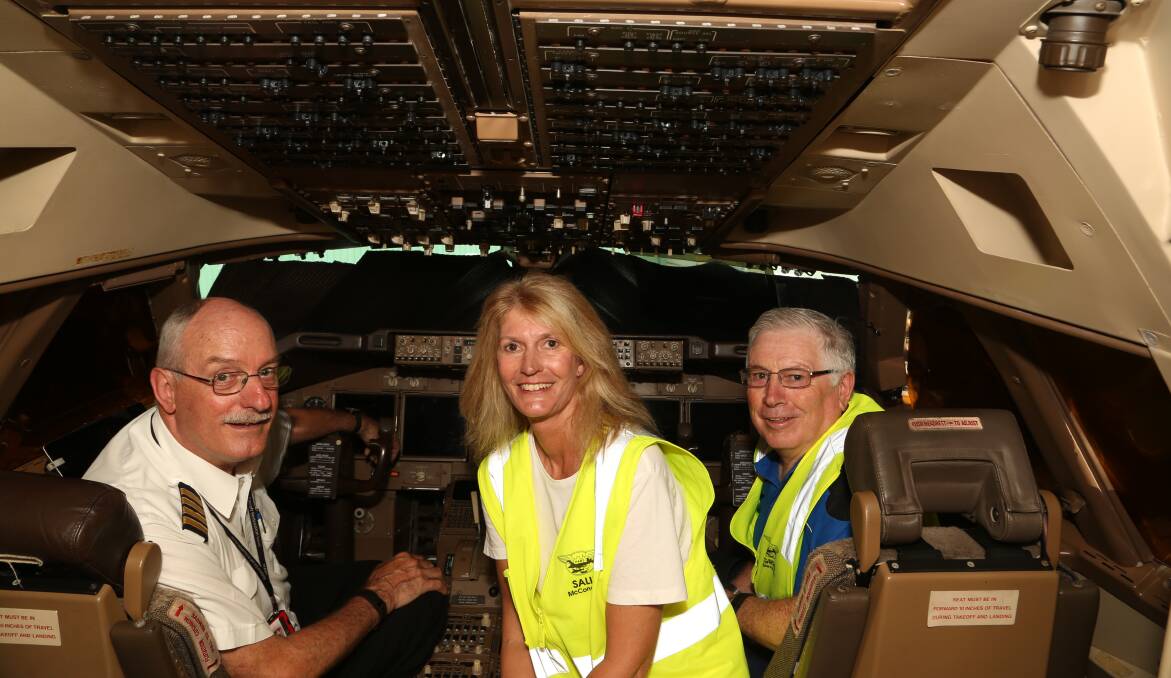 In the cockpit: Captain Sandy Howard, flight attendant Sally McConachy and turbine engineer Greg Stevenson inside the cockpit of the Boeing 747 at at HARS. Picture: Greg Ellis.
