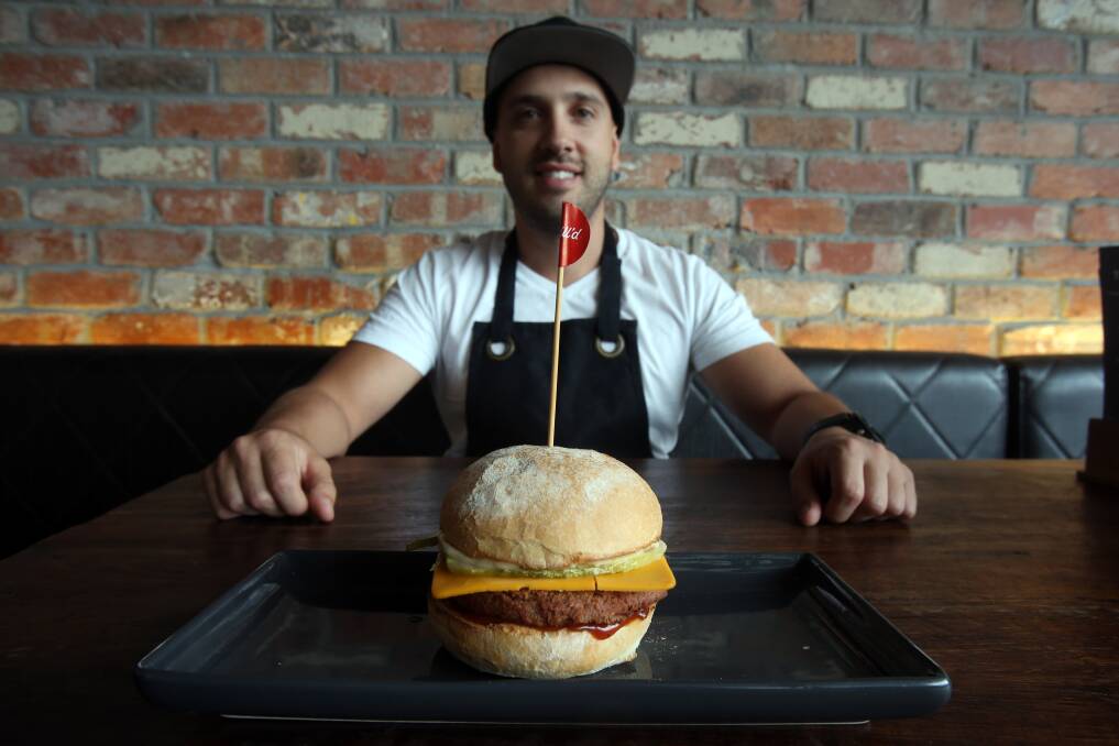 Grill'd Wollongong manager Allen Markovski with the new Vegan CheeseBurger at Grill'd. Picture: Robert Peet.


