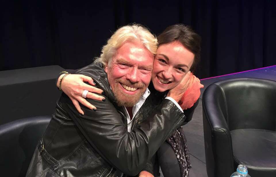 The first meeting: Lisa Burling on stage with Sir Richard Branson in Sydney. Now she has invited him to Wollongong in May.
