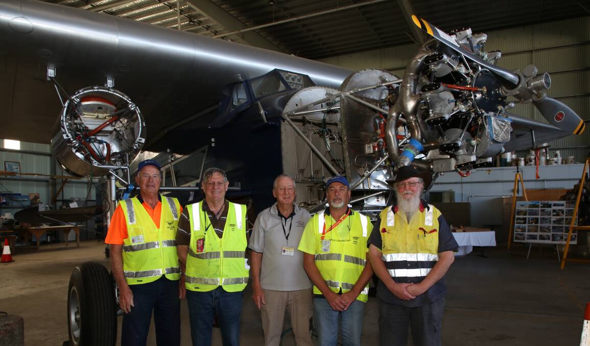 Historic moment: Jim Thurstan (centre) with other volunteers working on the Southern Cross replica at HARS who are expecting this first of the two wings engines to arrive this week. 