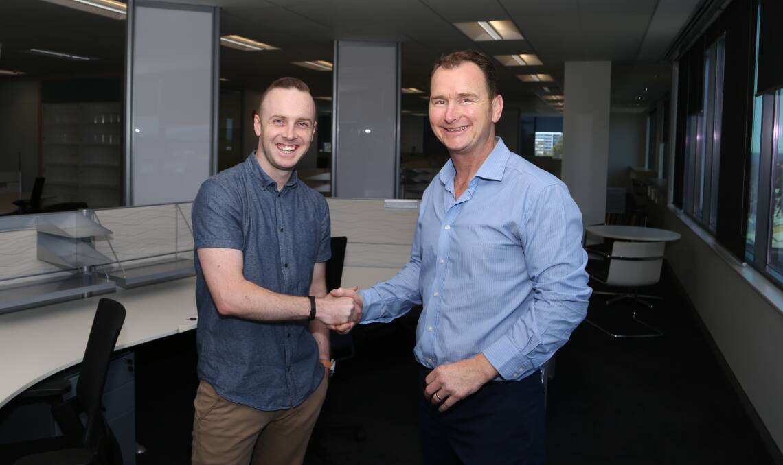 Shared services growth: Stellar call centre manager Dan Shaw with MMJ commercial leasing director Michal Croghan. Picture: Greg Ellis.
