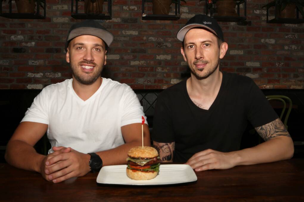 New for vegans and meat lovers: Allen Markovski and Rob Gorgievski with one of the first Beyond Meat burgers off the grill in Wollongong this week. Picture: Greg Ellis.
