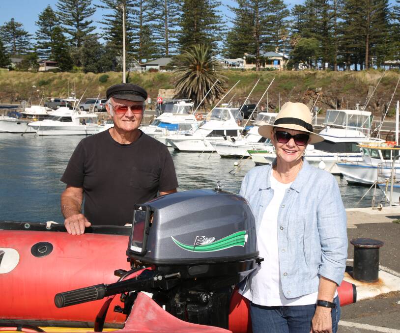 Clean, green boating: Ron Kelly and Lynelle Johnson with one of their electric outboards at Kiama Harbour.