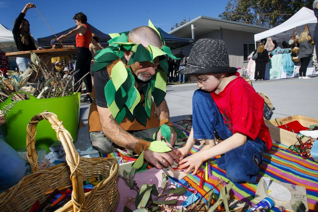 Sustainable education: Bohmer the Tree Whisperer helps Ada Pike-Wills, 9, do some tree inspired craft at Coledale Markets during National Tree Day on Sunday. Picture: Anna Warr.
