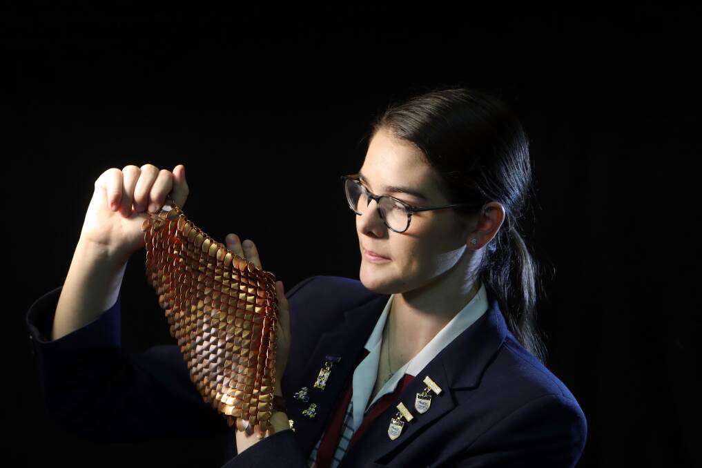 Busy year: Inspiring teenager Macinley Butson with her SMART ARMOUR breast shield for radiation treatment that is about to go into production. Picture: Sylvia Liber.
