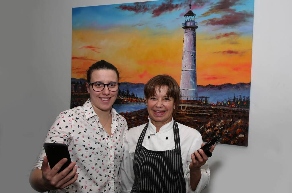 Embracing change: Nataly Sanchez and Marisa Tatangelo-Ferri at Table 426 in Corrimal are ready for Google Lens. Picture: Greg Ellis.