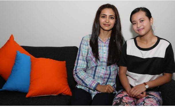 Helping others: After being helped by SCARF young refugee women Azita and Elizabeth volunteered to support other families in Wollongong. Picture: Greg Ellis.

