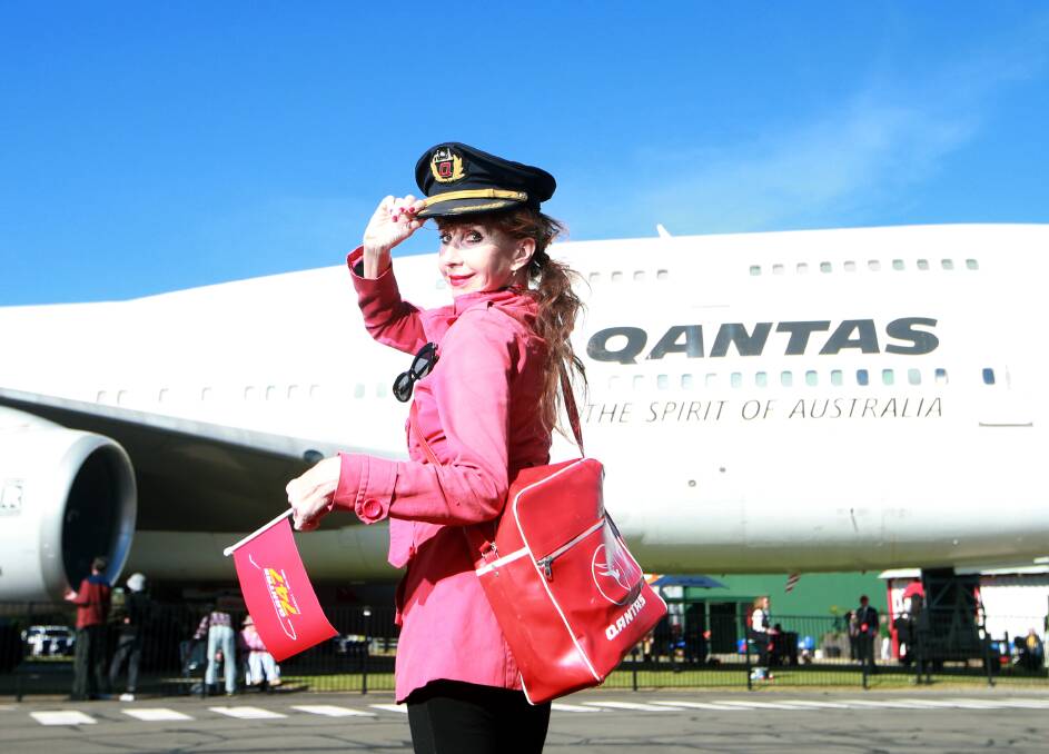 Dressed in retro to celebrate a century: Susie Lindeman in front of the first Qantas Boeing 747-400, now located at HARS. Picture: Sylvia Liber.