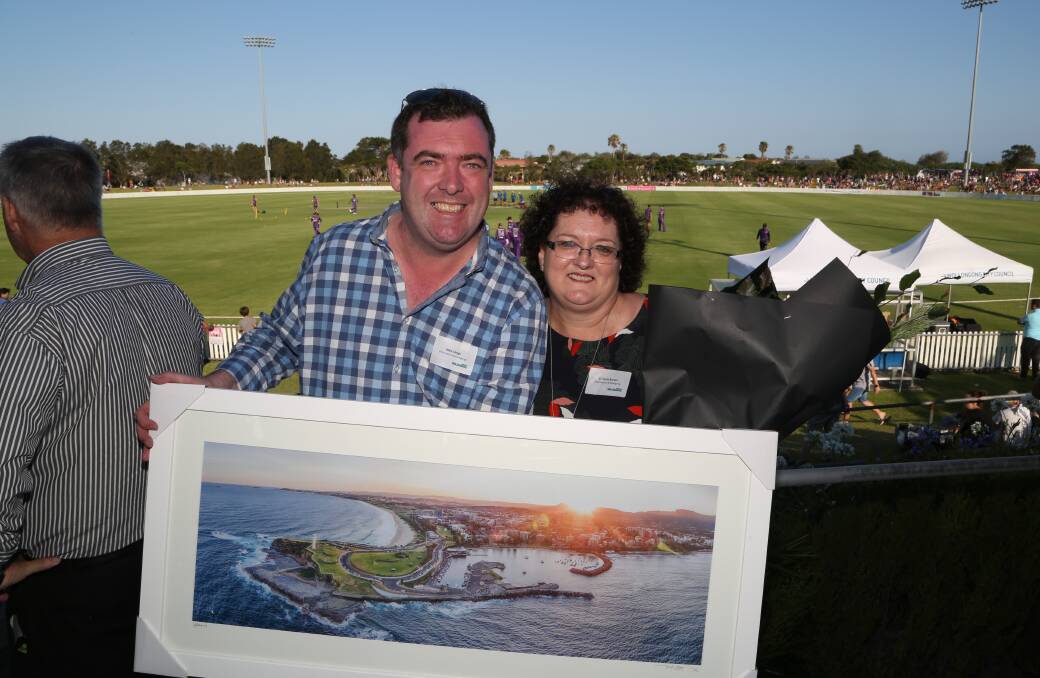 Thank you: Destination Wollongong general manager Mark Sleigh presents outgoing chair Tania Brown with a Dee Kramer print as a farewell gift. Picture: Greg Ellis.
