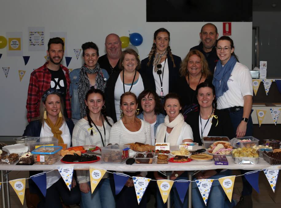 Hosts: The Disability Trust team who organised a Biggest Morning Tea for cancer research at its new headquarters at Spring Hill. Picture: Greg Ellis. 