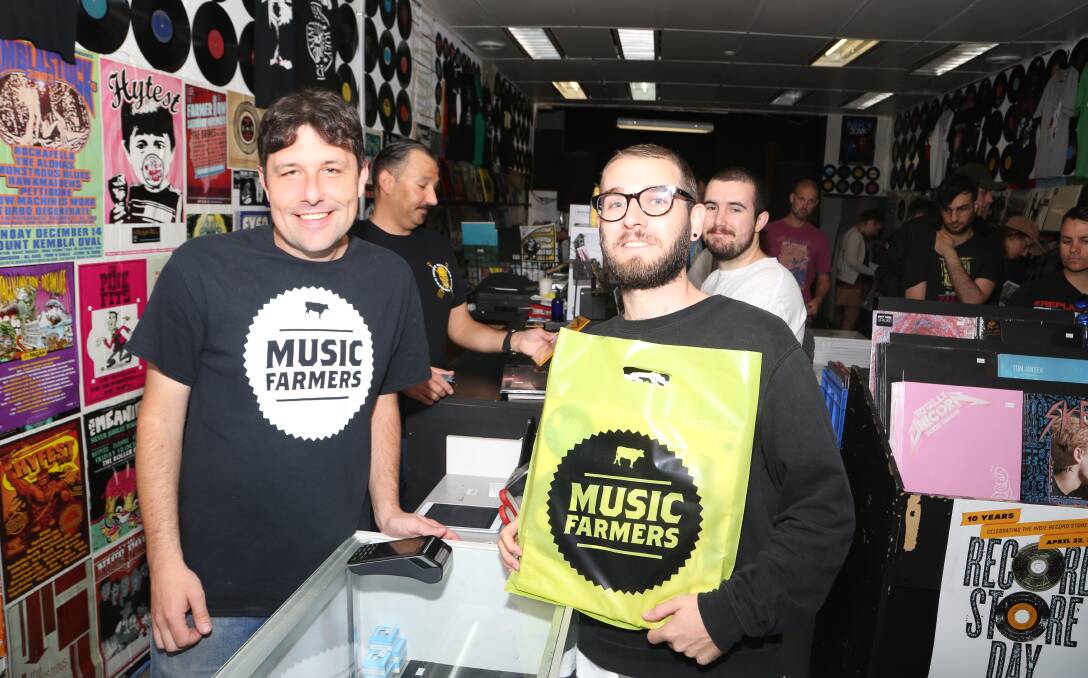 Record Store Day: Jeb Taylor serves Brendan Pfister at Music Farmers in Keira Street, Wollongong just after 9am on Saturday. Picture: Greg Ellis