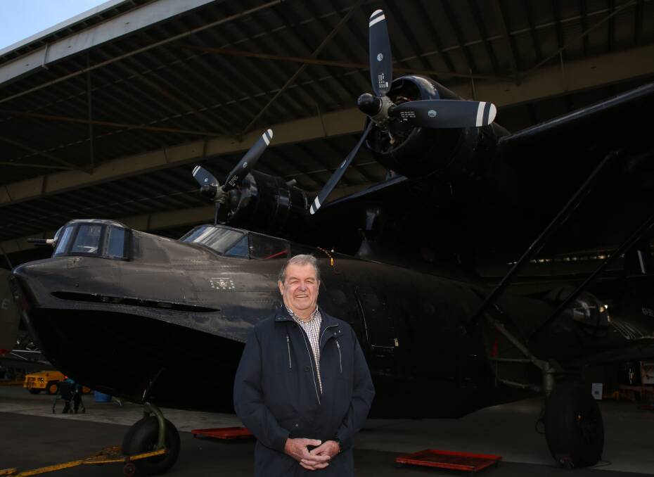 Mystery solved: John Walter Bissett-Amess, of Mount Warrigal, with the Catalina at HARS which is similar to the one his uncle was on board with nine other crew when it crashed in Irian Jaya. Picture: Greg Ellis.
