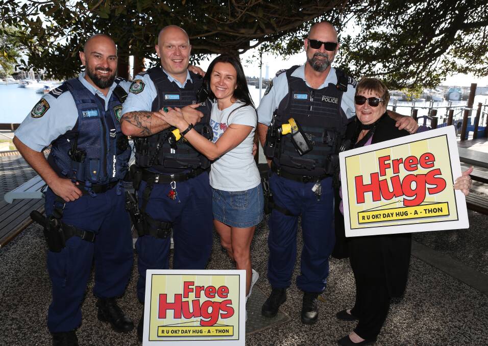 Dee Milenkovic and Vicki Clare offered hugs to everyone out early on sunny Friday morning at Wollongong Harbour. Picture: Greg Ellis.
.