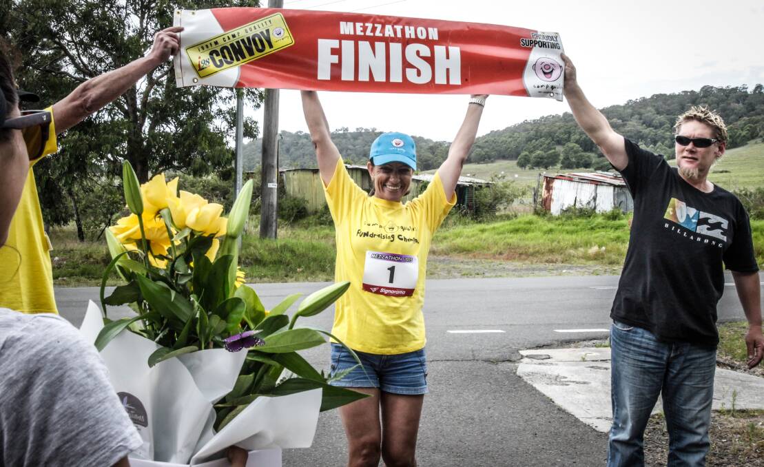 MEZZATHON: Mary Mouawad crosses the finish line at the end of her 50km walk for Convoy in 2015. Picture: GEORGIA MATTS
