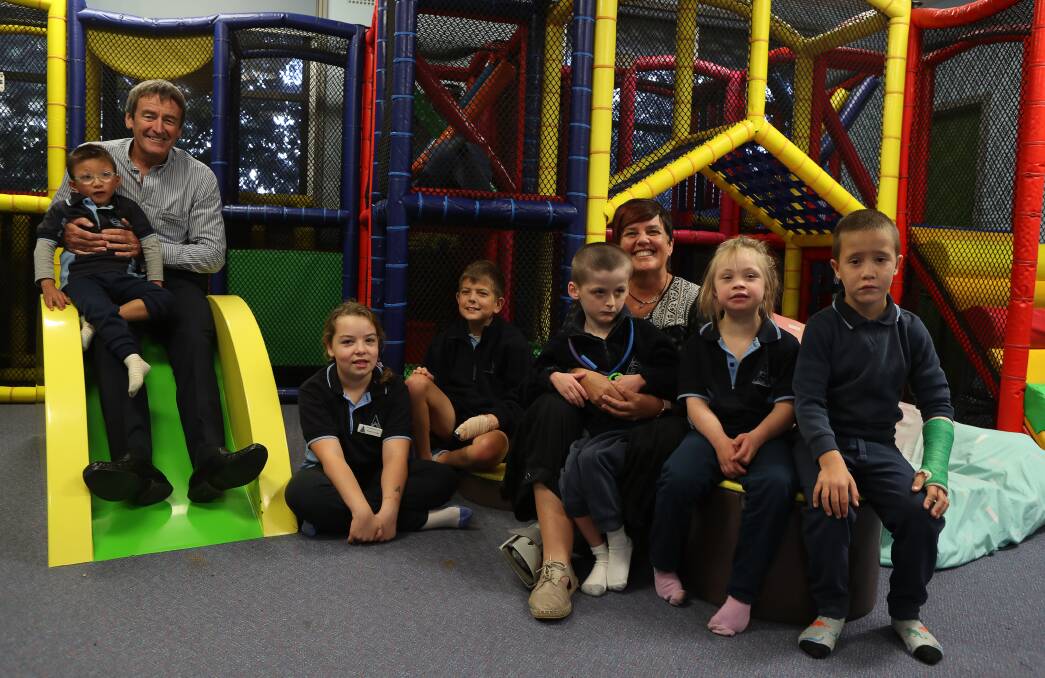 Sensory fun: Dapto Mall centre manager Glenn Cochrane with Peterborough School principal Sue Corkery and students in the new playground. Picture: Robert Peet.
