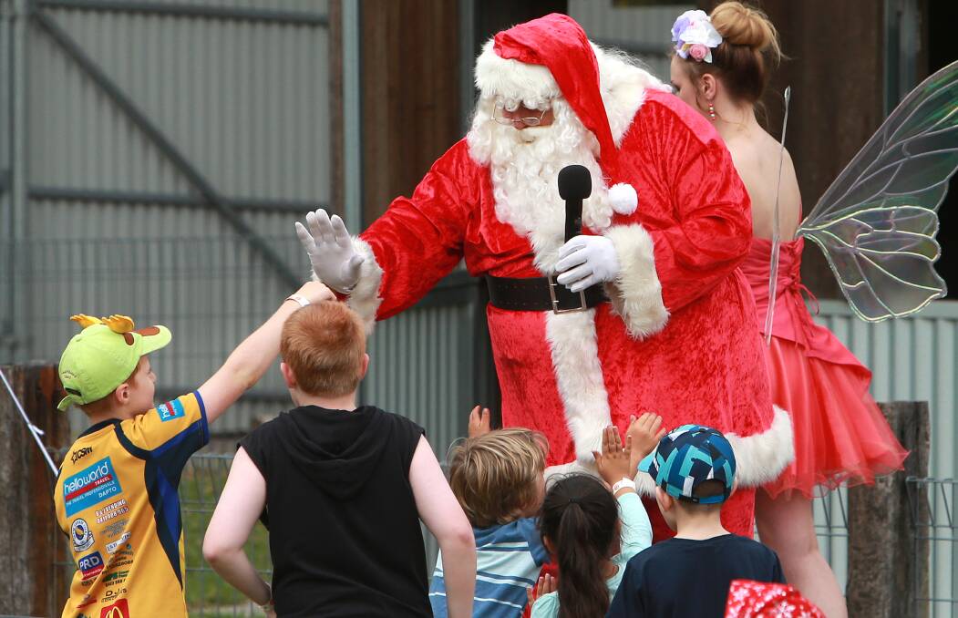 Granting wishes: Santa greets children at the 2020 KidzWish Christmas Party at Symbio Wildlife Park. Picture: Sylvia Liber.