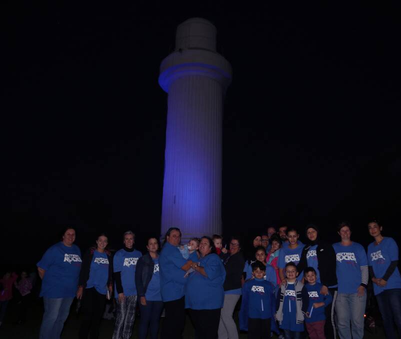 Beacon: Hundreds gathered at Flagstaff Hill on Sunday night to see the lighthouse turn blue to raise more awareness and understanding about autism. Picture: Greg Ellis.
