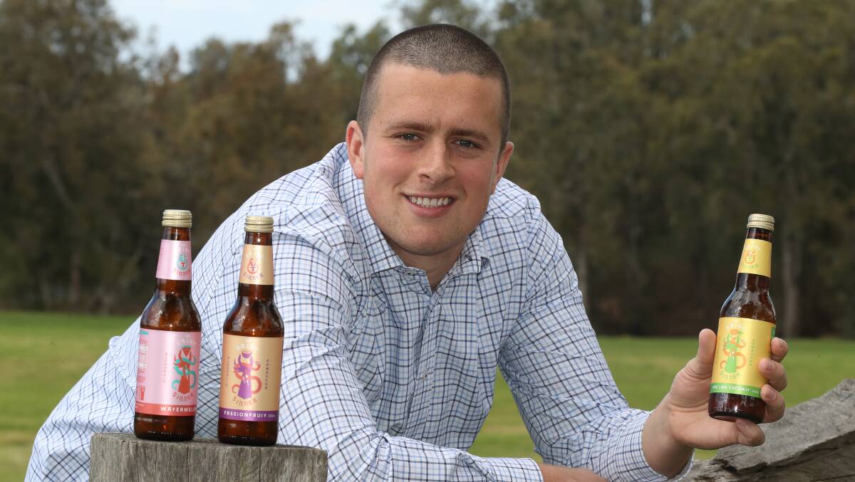 New brew: Riley Goldspink-Lord with some bottles of the new low sugar, gluten and preservative free, organic kombucha being brewed at Unanderra for the more health-conscious drinker. Picture: Robert Peet.