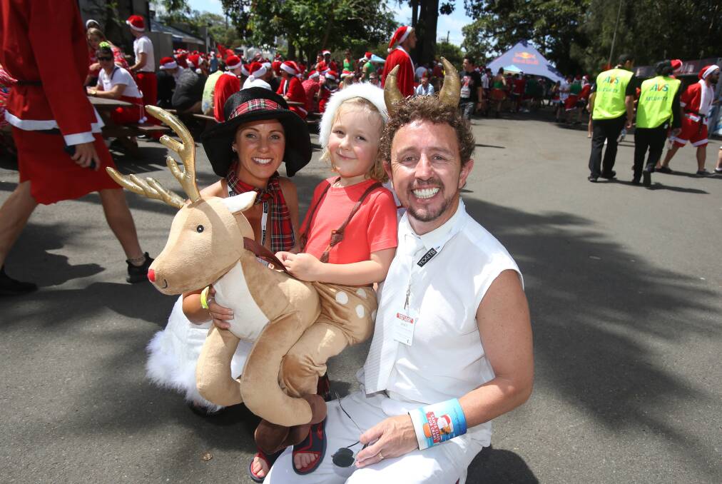 Bigger is better: Neil Webster and his family early in the afternoon at North Gong Hotel during the 2017 Santa Claus Pub Crawl. Picture: Robert Peet.

