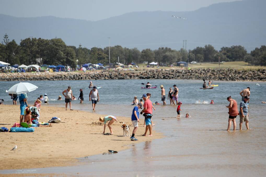Staying cool: Hundreds of people were out early in Shellharbour finding ways to stay near the lake. Picture: Adam McLean.
