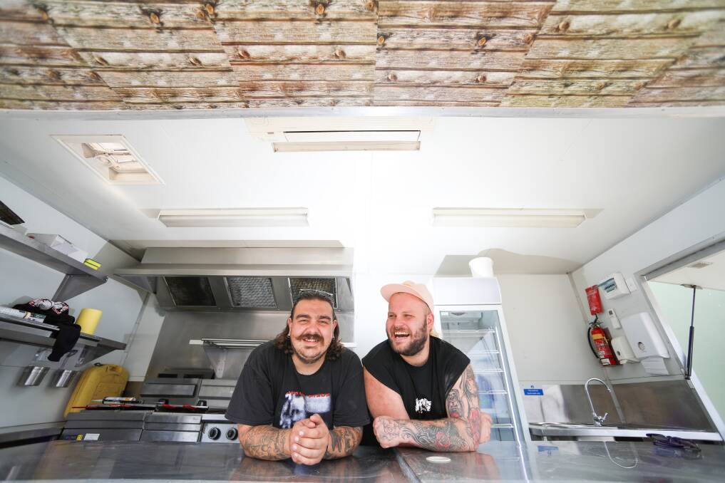 Foodie treat: Andrew Juskiw and Barry Pearson in Hank's Fried Chicken van in front of Fairy Meadow's soon to open Principal Brewing. Picture: Adam McLean.