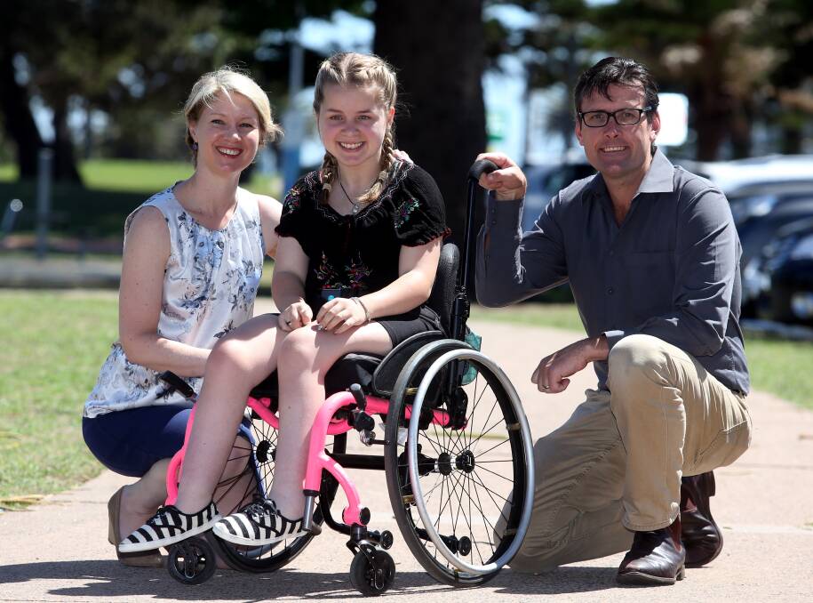 Gift of mobility: Belinda Dawson, Clara Bates and Troy McDonald celebrate the news Clara is about to get a new wheelchair thanks to the generosity of 100 people. Picture: Robert Peet.
