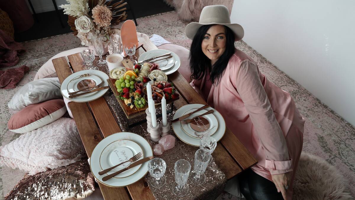 Pink with a purpose: Rachel Rogan with a pink picnic setting at Perrie and Peach Styling Company in Corrimal. Picture: Robert Peet.
