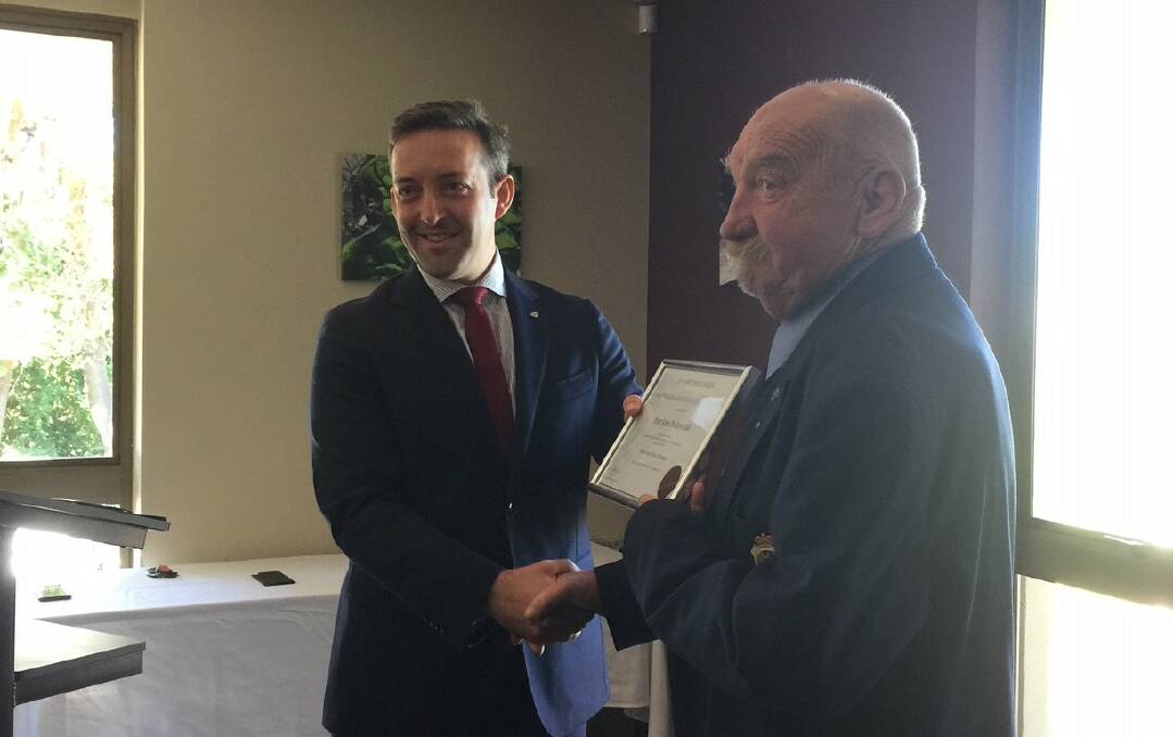 RSL NSW president James Brown present RSL's highest honour to Peter Poulton at RSL Figtree Bowling Club. 