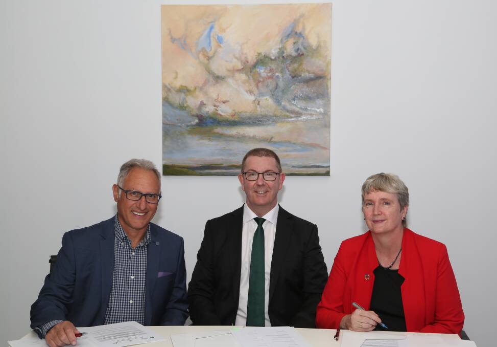 Looking ahead: Eddy De Gabrielle, Graham Lancaster and  Dr Grace McCarthy sign a Memorandum of Understanding for the Illawarra Leadership Program. Pic: Greg Ellis.
