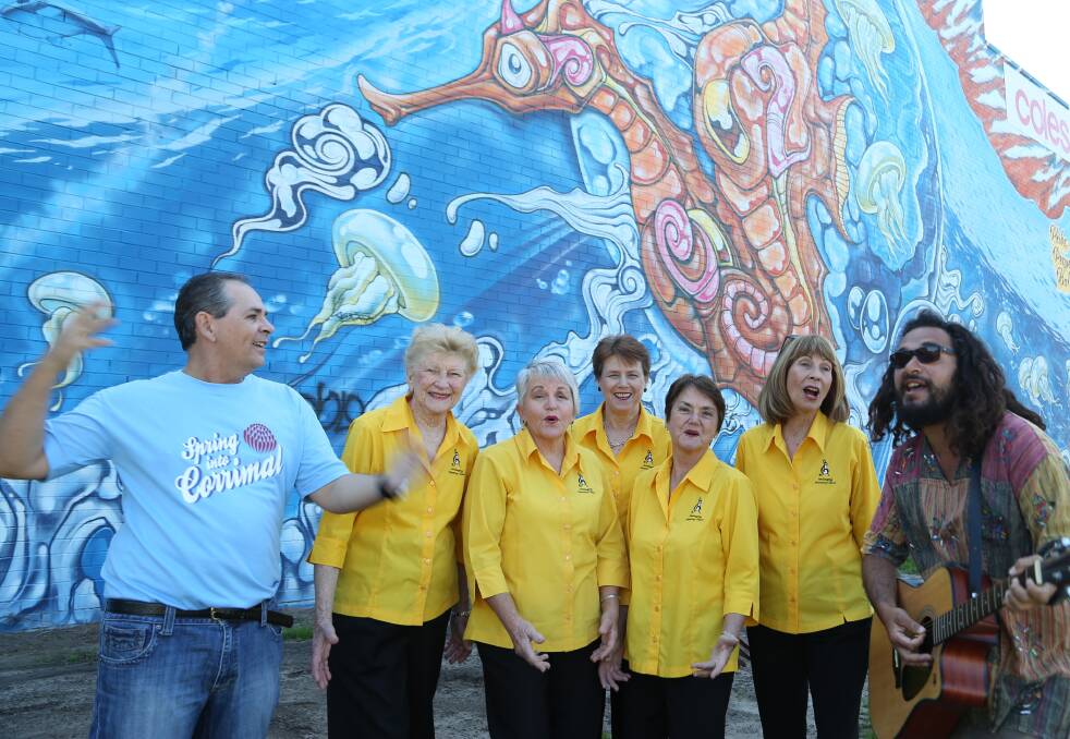 Corrimal Chamber of Commerce president Paul Boultwood, Wollongong Harmony Chorus members Isla Melville-Jones, Barbara Scott, Ilona Barr, Linda Parker and Jan McCarthy and Oliver of Corrimal (Oliver Denning) warm up for Spring Into Corrimal with some singing. Picture by Greg Ellis.

