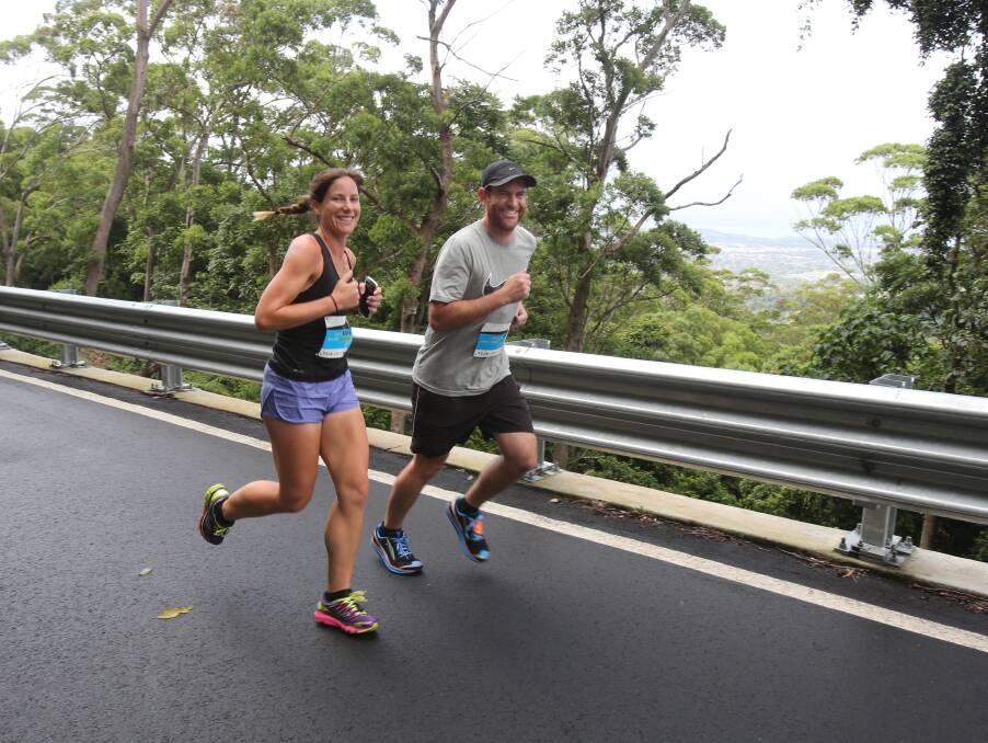 On the pace: Roanna Whittle and Andrew Whittle, of Kanahooka, head for the summit during the 5km Keira Challenge. Picture: Robert Peet.
