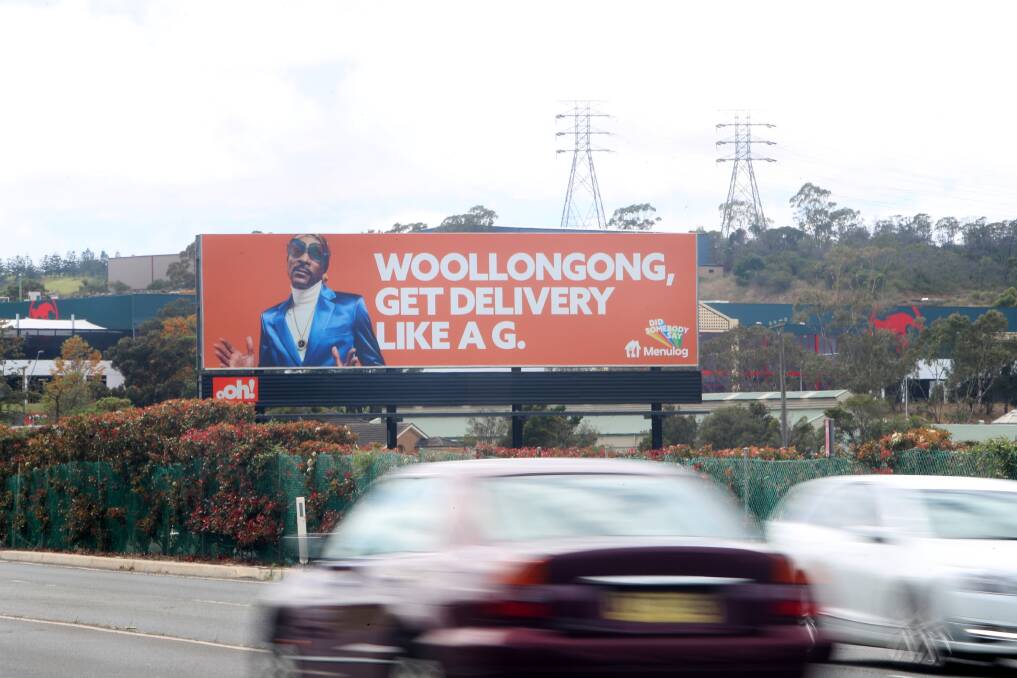 Who has noticed this? The giant Menulog billboard driving north along the Princes Highway from Dapto past Kembla Grange Racecourse towards Wollongong, Picture: Sylvia Liber.