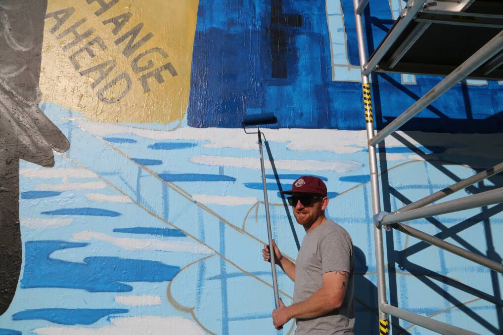 Promotional painting: Wollongong street artist Kane Trait Horspool working on a mural in MacCabe Park to promote the Green Flicks competition. Picture: Greg Ellis.
