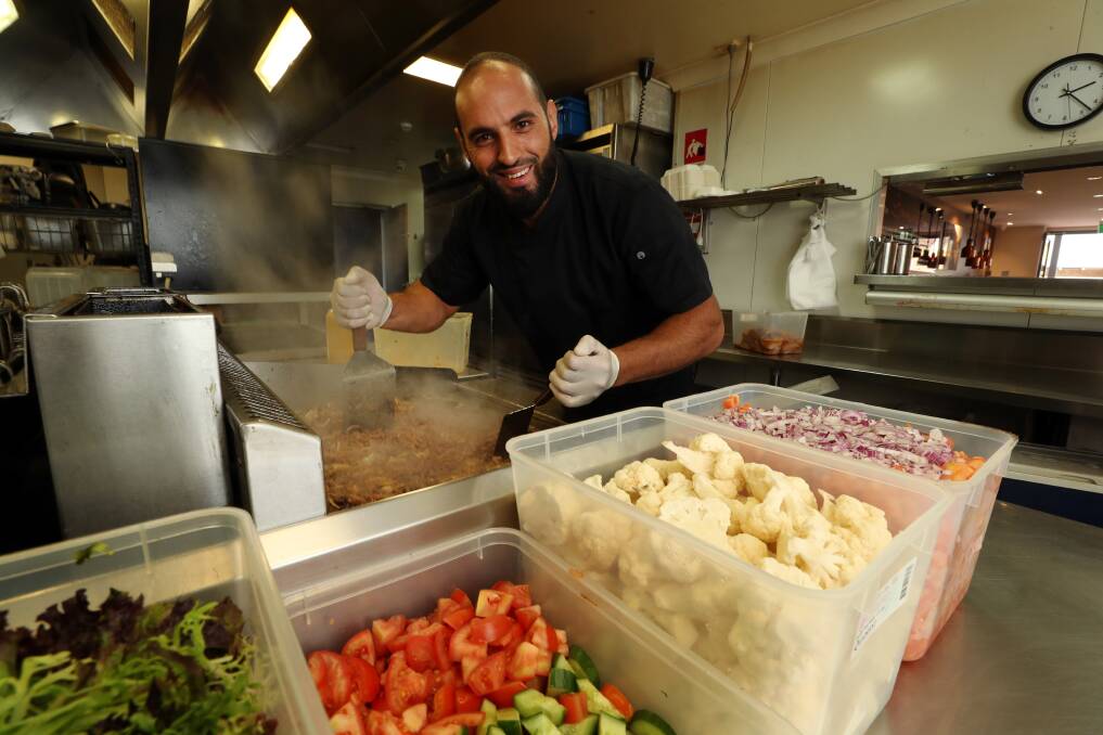 Leading from the front: Omar Nemer prepares meals at Samaras Restaurant Woonona on Thursday afternoon to deliver to the COVID testing clinic workers in Figtree on New Year's Eve. Picture: Robert Peet.