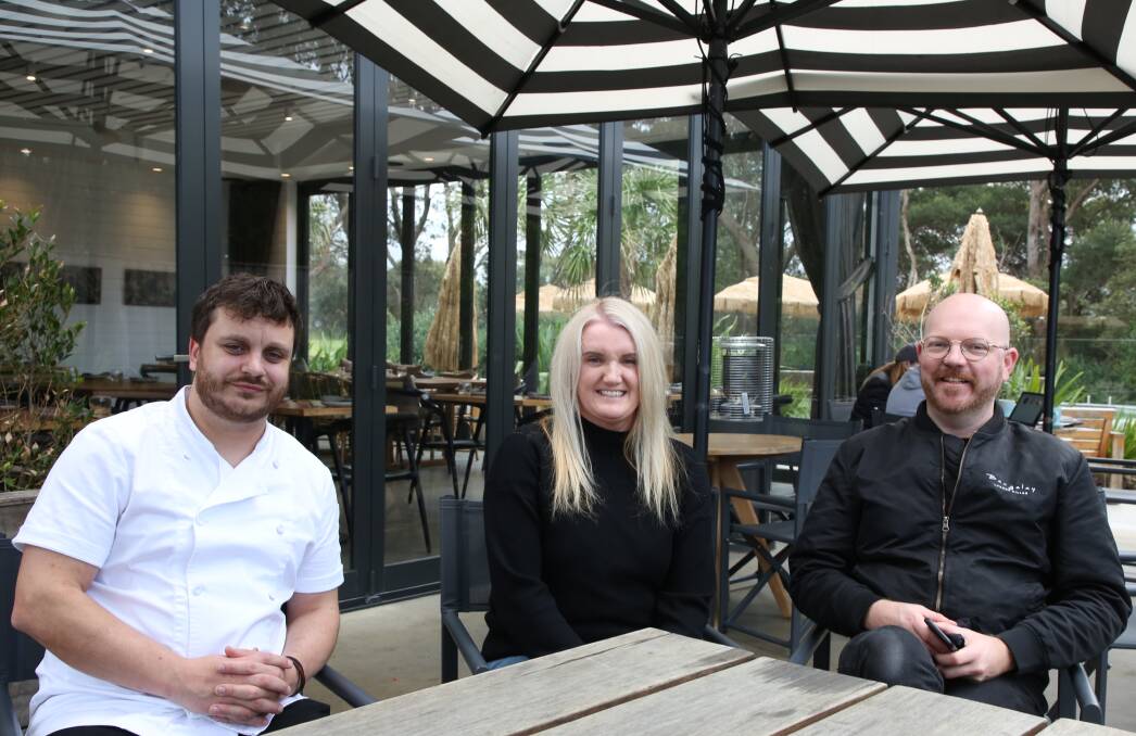 Hat quality dining: Chef Simon Evans, owner Michelle Bishop and restaurant manager Ronnie Gorman celebrate some good news outside Bangalay Dining. Picture: Greg Ellis.

